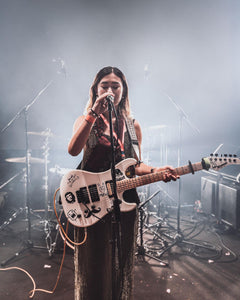 Performing artist singing with guitar.